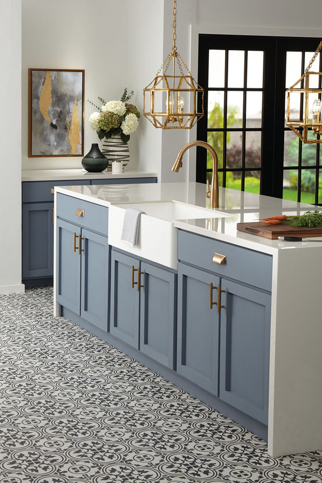 Black and white floor tile in kitchen with blue cabinets 